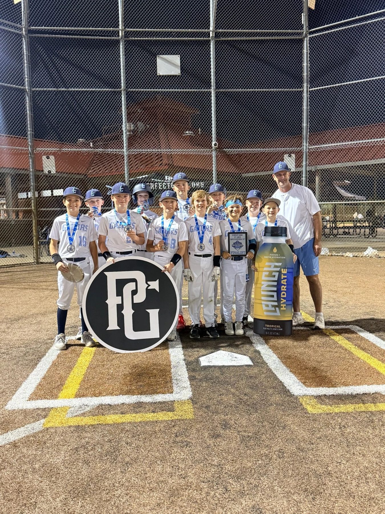 Youth baseball team gathered at home plate