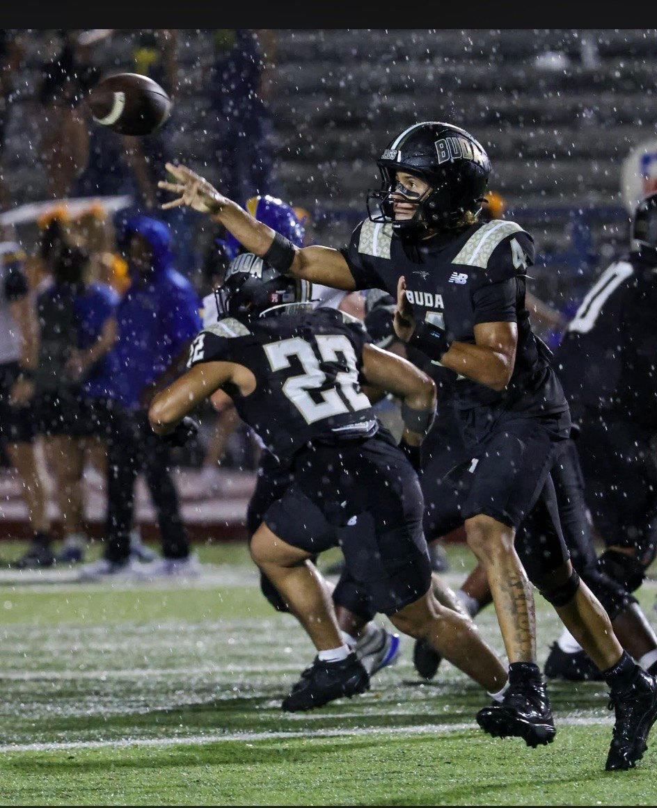Quarterback throwing in the rain