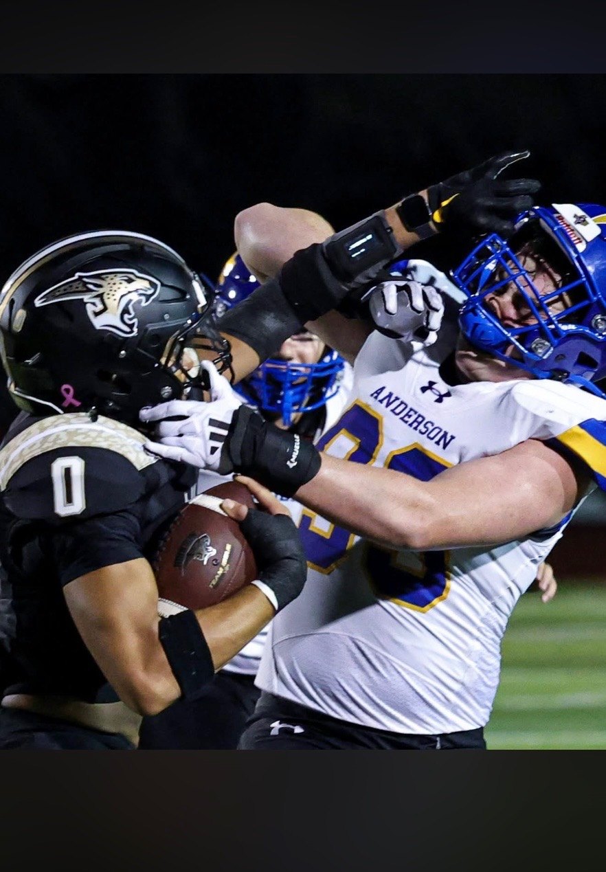 Ball carrier fighting through a tackle