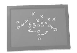Grayscale football play diagram on a whiteboard, representing traditional coaching methods